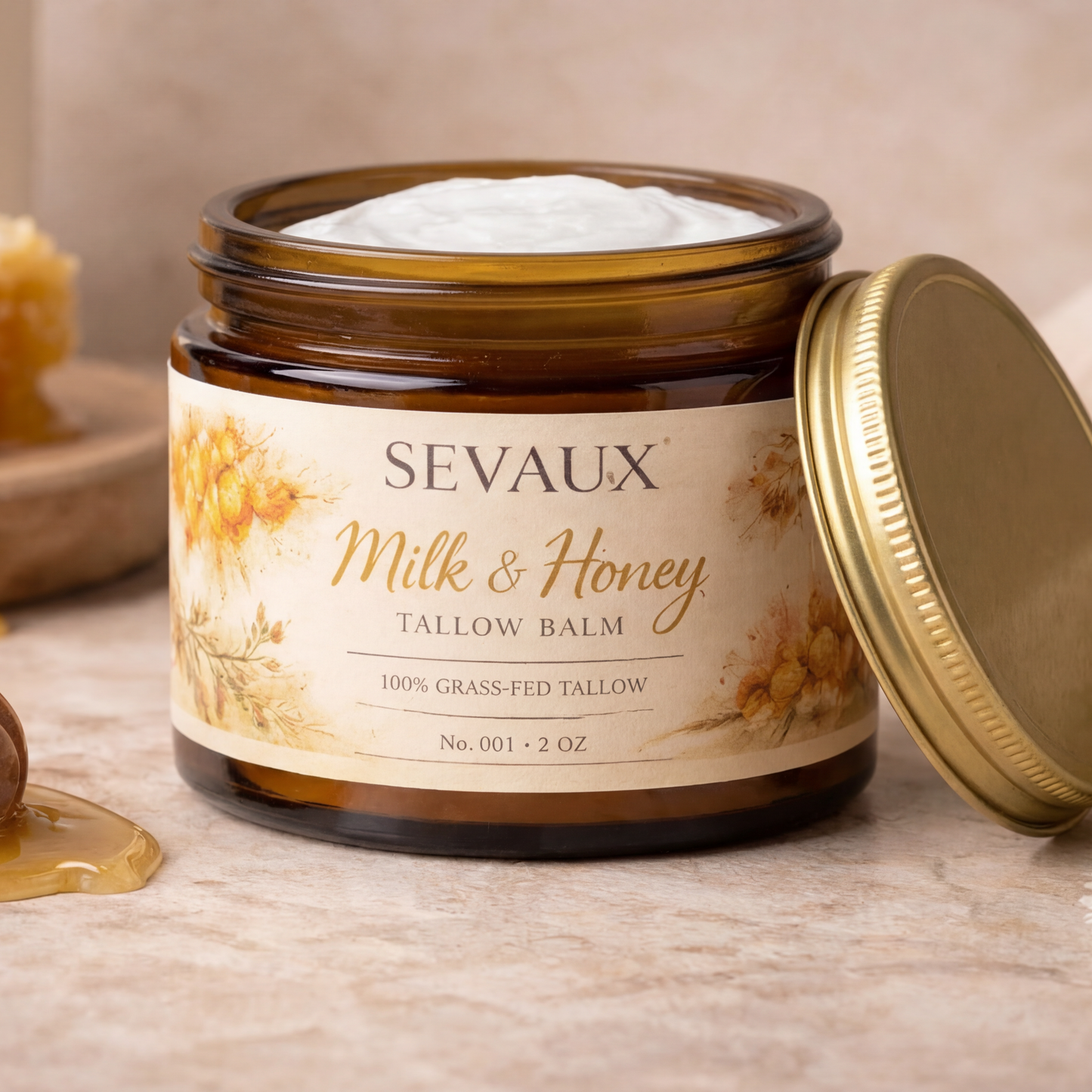 Sevaux Milk & Honey balm jar with honeycomb and honey dipper on a wooden surface